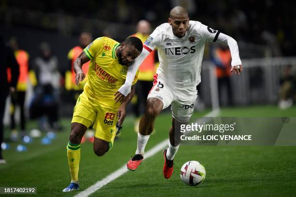 Nantes' French forward Marcus Coco fights for the ball with Nice's French defender Jean-Clair Todibo during the French L1 football match between FC...