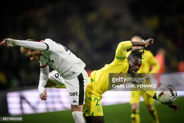 Nice's French defender Melvin Bard fights for the ball with Nantes' Nigerian forward Moses Simon during the French L1 football match between FC...
