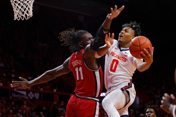 Terrence Shannon Jr. #0 of the Illinois Fighting Illini attempts a shot as Clifford Omoruyi of the Rutgers Scarlet Knights defends during the first...