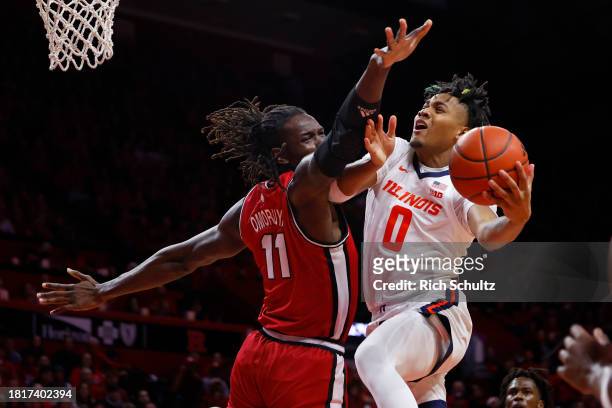 Terrence Shannon Jr. #0 of the Illinois Fighting Illini attempts a shot as Clifford Omoruyi of the Rutgers Scarlet Knights defends during the first...