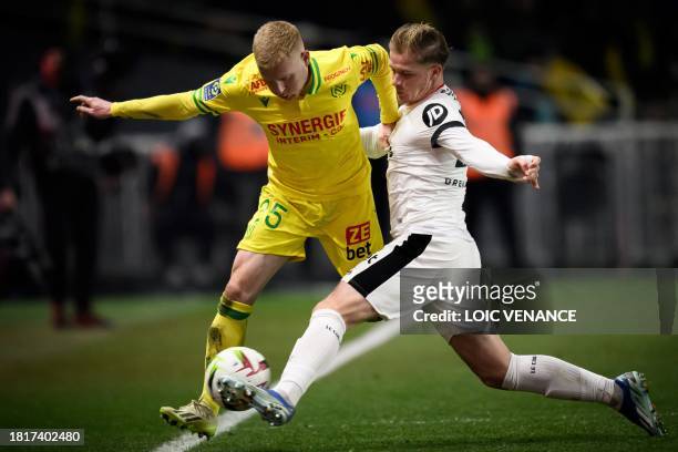 Nantes' French midfielder Florent Mollet fights for the ball with Nice's French defender Melvin Bard during the French L1 football match between FC...