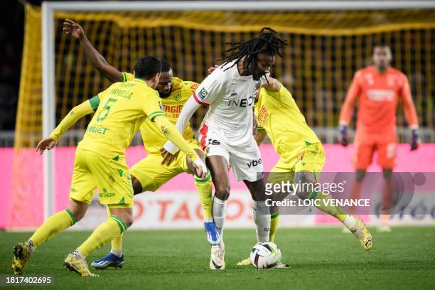 Nantes' French forward Marcus Coco fights for the ball with Nice's French midfielder Khephren Nice's French midfielder Khephren Thuram during the...