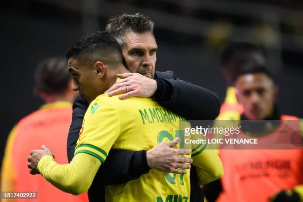 Nantes' French head coach Jocelyn Gourvennec congratulates Nantes' Egyptian forward Mostafa Mohamed during the French L1 football match between FC...