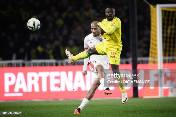 Nice's French defender Jean-Clair Todibo fights for the ball with Nantes' Nigerian forward Moses Simon during the French L1 football match between FC...