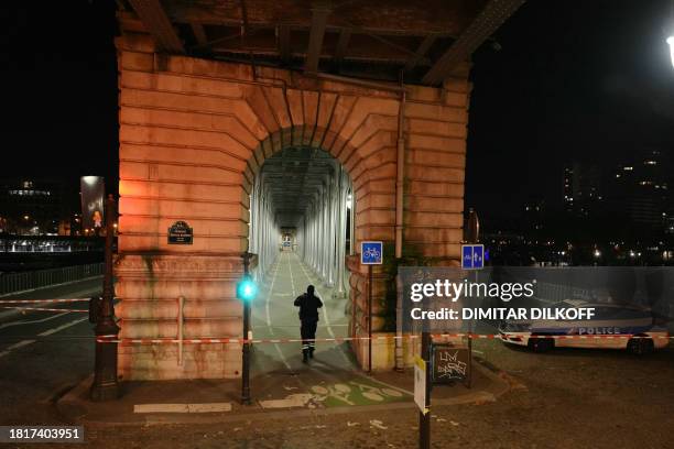 Police officer patrols in a security perimeter set after one person was killed and two others wounded in a knife attack in Paris, on December 2,...