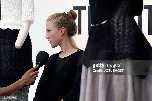 French designer Alice Lemoine speaks to journalists as her creations are on display during the 2014 Spring/Summer ready-to-wear collection fashion...