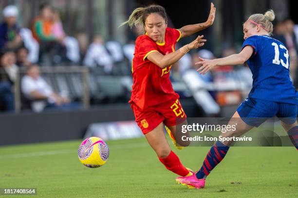 China PR midfielder Tang Jiali and United States midfielder Jenna Nighswonger fight for the ball during an international friendly soccer match...