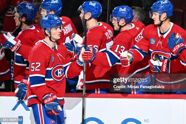 Justin Barron of the Montreal Canadiens celebrates his goal with teammates on the bench during the first period against the Detroit Red Wings at the...