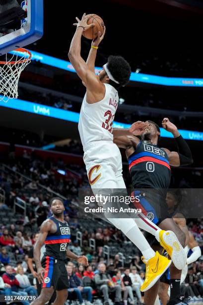 Jarrett Allen of the Cleveland Cavaliers shoots the ball against Jalen Duren of the Detroit Pistons during the first quarter at Little Caesars Arena...