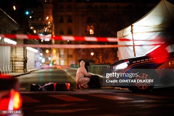Forensic police officer works at the scene of a stabbing in Paris on December 2, 2023. A person known to the French authorities as a radical Islamist...