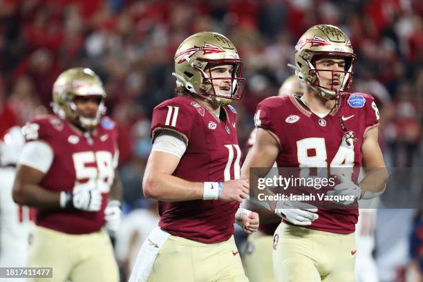 Brock Glenn of the Florida State Seminoles and Kyle Morlock of the Florida State Seminoles jog off the field during the first half against the...