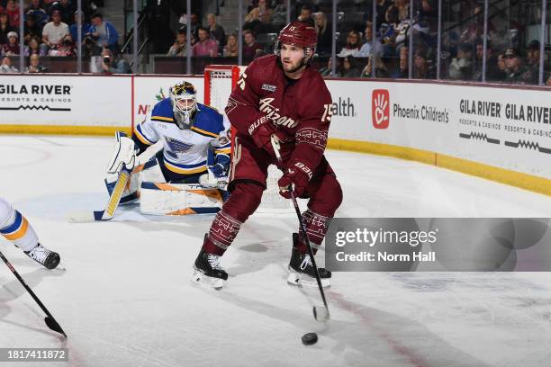 Alex Kerfoot of the Arizona Coyotes looks to pass to a teammate during the first period of the game against the St Louis Blues at Mullett Arena on...