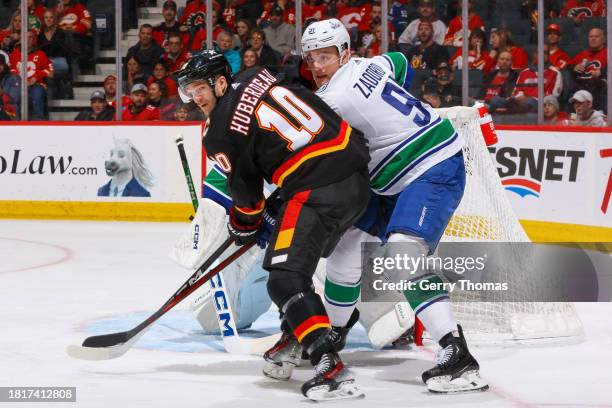 Jonathan Huberdeau of the Calgary Flames skates against Nikita Zadorov of the Vancouver Canucks at the Scotiabank Saddledome on December 02, 2023 in...