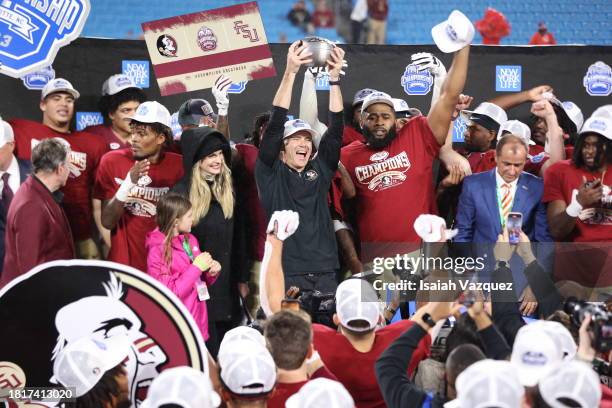 Head coach Mike Norvell of the Florida State Seminoles holds up the trophy after the Florida State Seminoles defeat the Louisville Cardinals, 16-6,...