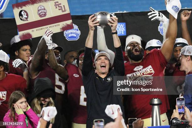 Florida State Seminoles head coach Mike Norvell holds up the trophy during the ACC Football Championship Game between the Louisville Cardinals and...
