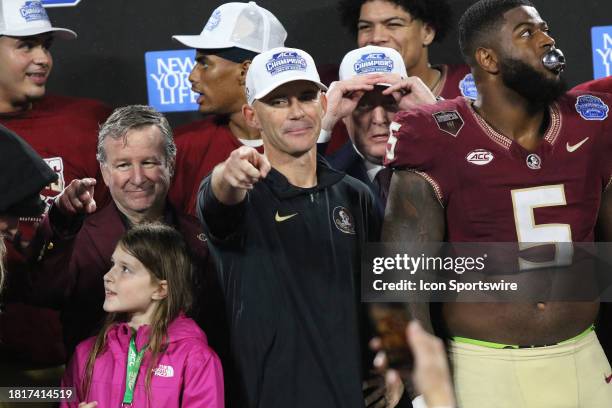 Florida State Seminoles head coach Mike Norvell points to a friend during the awards presentation during the ACC Football Championship Game between...