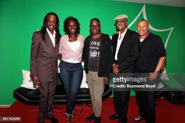 Verdine White, Philip Bailey and Ralph Johnson of Earth, Wind & Fire, poses for photos with Radio Producer Tracy Kendrick and on-air personality Herb...