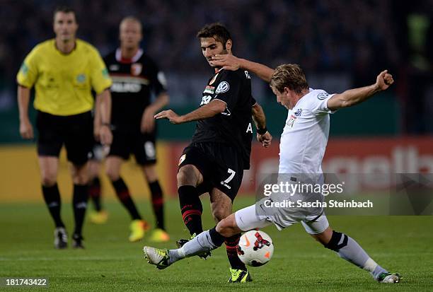 Halil Altintop of Augsburg is challenged by Kevin Schoeneberg of Muenster during DFB Cup second round match between Preussen Muenster and FC Augsburg...