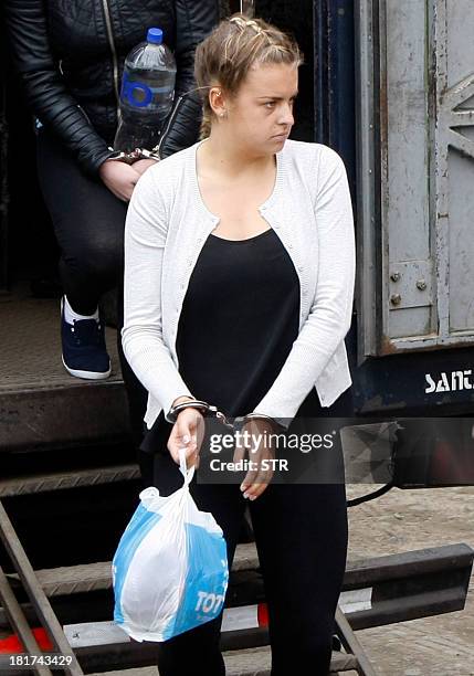 Briton Melissa Reid and companion Irishwoman Michaella McCollum disembark handcuffed from a truck in front of the Sarita Colonia Jailhouse Court in...