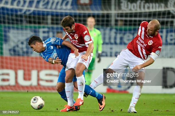 Roberto Firmino of Hoffenheim battles for the ball with Marc Andre Kruska and Ivica Banovic of Cottbus during the DFB Cup second round match between...