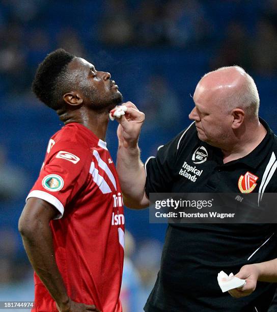 Boubacar Sanogo of Cottbus injury is treated during the DFB Cup second round match between TSG 1899 Hoffenheim and FC Energie Cottbus at Wirsol...