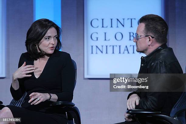 Sheryl Sandberg, chief operating officer of Facebook Inc., left, speaks with Bono, singer for the band U2 and co-founder of ONE and , during the...