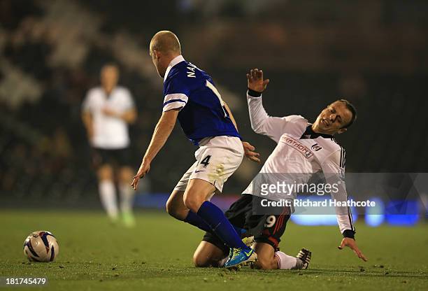 Dimitar Berbatov of Fulham goes down after a tackle with Steven Naismith of Everton during the Captial One Cup Third Round match between Fulham and...