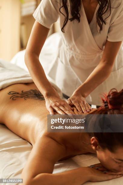 back massages are great to relief tensions and relax - spa treatment stock pictures, royalty-free photos & images