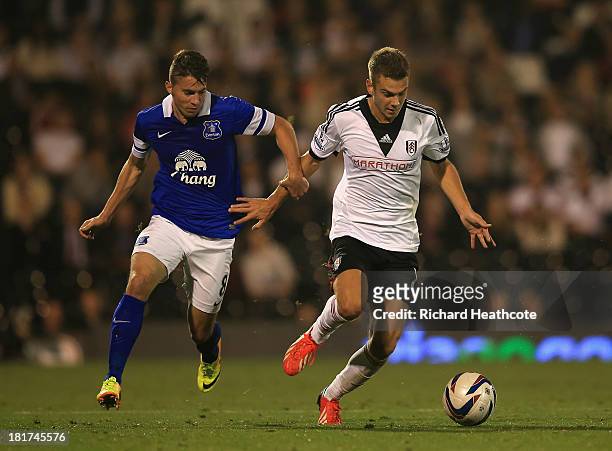 Alex Kacaniklic of Fulham holds off Bryan Oviedo of Everton during the Captial One Cup Third Round match between Fulham and Everton at Craven Cottage...
