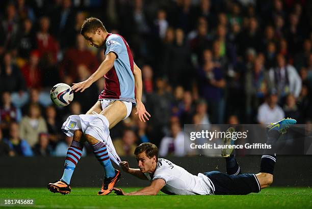 Jan Vertonghen of Tottenham Hotspur hangs on to the shorts of Nicklas Helenius of Aston Villa during the Capital One Cup third round match between...