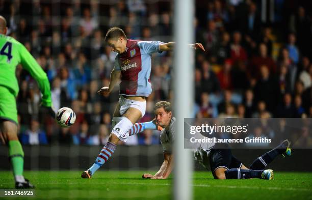 Jan Vertonghen of Tottenham Hotspur hangs on to the shorts of Nicklas Helenius of Aston Villa during the Capital One Cup third round match between...