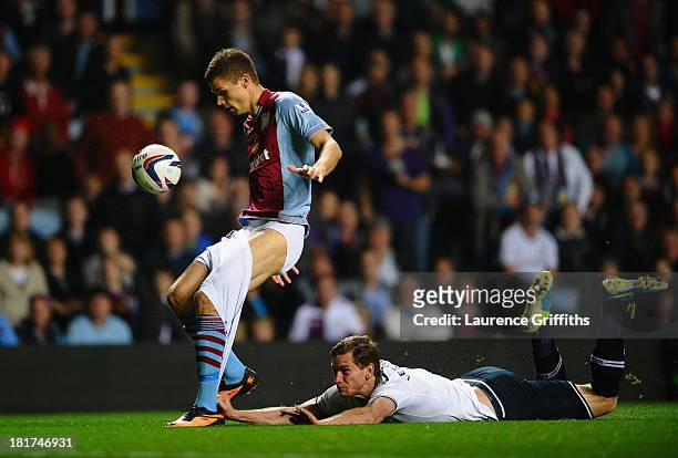 Jan Vertonghen of Tottenham Hotspur hangs on to the shorts of Nicklas Helenius of Aston Villa during the Capital One Cup third round match between...