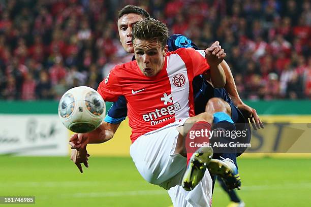 Nicolai Mueller of Mainz is challenged by Jonas Hector of Koeln during the DFB Cup second round match between 1. FSV Mainz 05 and 1. FC Koeln at...