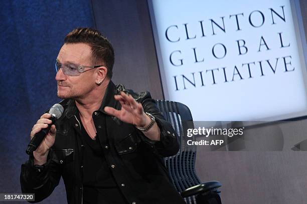 Bono, lead singer of U2 attends the Clinton Global Initiative on September 24, 2013 in New York. AFP PHOTO/Mehdi Taamallah