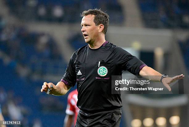 Referee Peter Sippel gestures during the DFB Cup second round match between TSG 1899 Hoffenheim and FC Energie Cottbus at Wirsol Rhein-Neckar-Arena...
