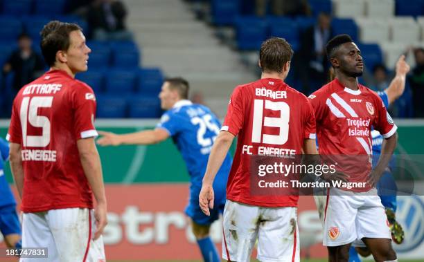 Alexander Bittroff, Julian Boerner and Boubacar Sanogo of Cottbus look dejected after Niklas Suehle is scoring his teams opening goal during the DFB...