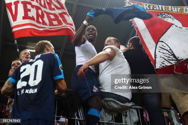 Marcel Risse and Anthony Ujah of Koeln celebrate with the fans after the DFB Cup second round match between 1. FSV Mainz 05 and 1. FC Koeln at Coface...