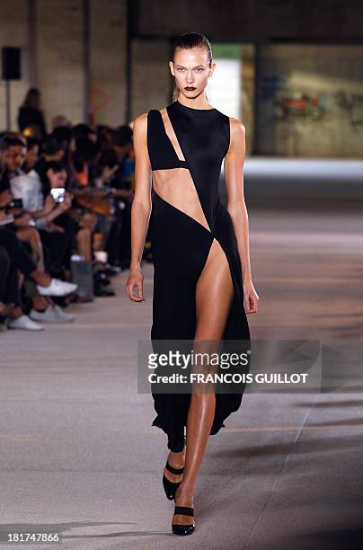 Model Karlie Kloss presents a creation by Anthony Vaccarello during the Spring/Summer 2012 ready-to-wear collection show, on September 27, 2011 in...