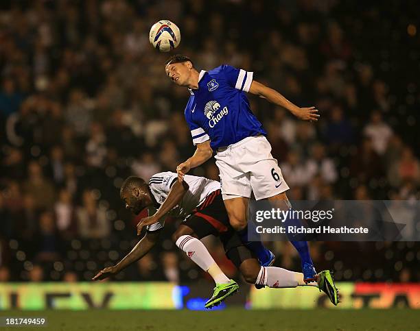 Phil Jagielka of Everton challenges Darren Bent of Fulham during the Captial One Cup Third Round match between Fulham and Everton at Craven Cottage...