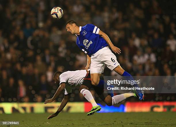Phil Jagielka of Everton challenges Darren Bent of Fulham during the Captial One Cup Third Round match between Fulham and Everton at Craven Cottage...