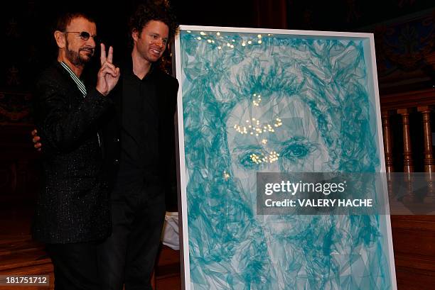 British artist and former drummer for the Beatles Ringo Starr and British artist Benjamin Shine pose next to Shine's new portrait in tulle netting of...