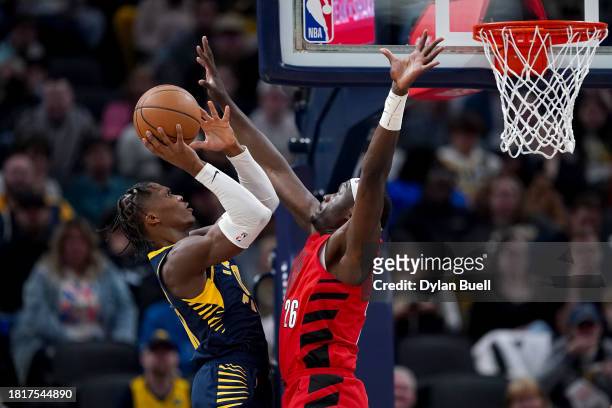 Bennedict Mathurin of the Indiana Pacers attempts a shot against Duop Reath of the Portland Trail Blazers in the second quarter at Gainbridge...
