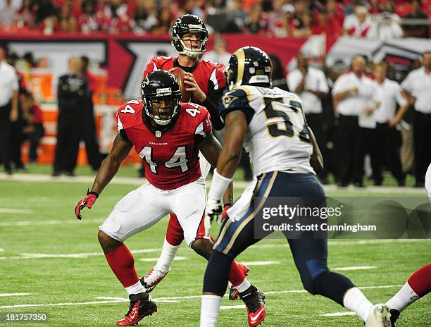 Jason Snelling of the Atlanta Falcons blocks against Alec Ogletree of the St. Louis Rams at the Georgia Dome on September 15, 2013 in Atlanta,...