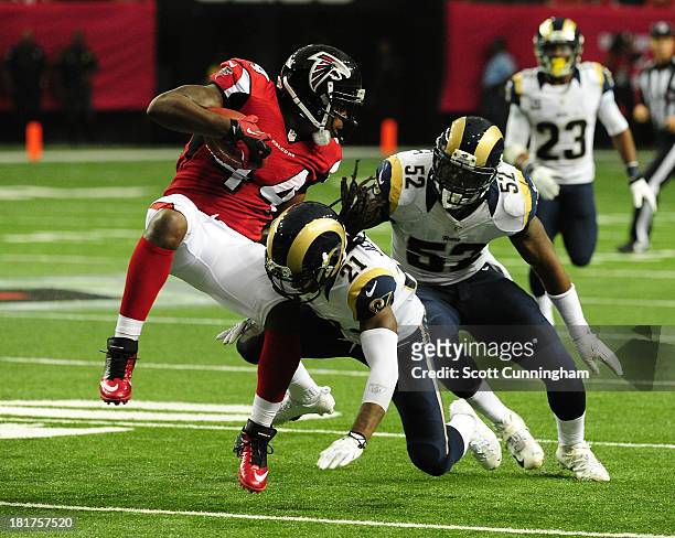 Jason Snelling of the Atlanta Falcons is tackled by Janoris Jenkins and Alec Ogletree of the St. Louis Rams at the Georgia Dome on September 15, 2013...