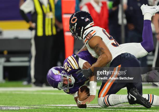 Montez Sweat of the Chicago Bears sacks Joshua Dobbs of the Minnesota Vikings during the first quarter at U.S. Bank Stadium on November 27, 2023 in...