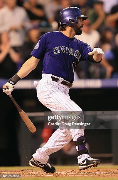 Todd Helton of the Colorado Rockies hits an RBI single off of John Lackey of the Boston Red Sox to score Michael Cuddyer of the Colorado Rockies and...