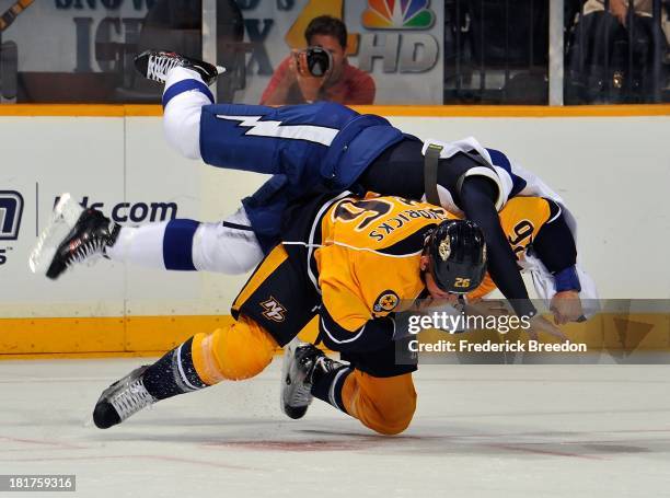 Matt Hendricks of the Nashville Predators flips B.J. Crombeen of the Tampa Bay Lightning during a fight at Bridgestone Arena on September 24, 2013 in...