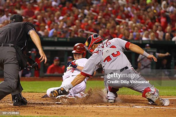 Yadier Molina of the St. Louis Cardinals is tagged out at home by Wilson Ramos of the Washington Nationals in the fourth inning at Busch Stadium on...