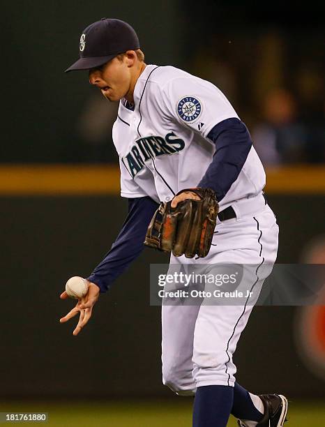 Shortstop Brad Miller of the Seattle Mariners can't come up with an infield single off the bat of Alex Gordon of the Kansas City Royals in the first...