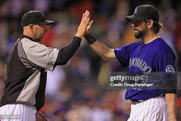 Manager Walt Weiss of the Colorado Rockies and Todd Helton of the Colorado Rockies celebrate their 8-3 victory over the Boston Red Sox at Coors Field...